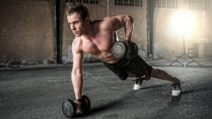 Man lifting weights in the gym as part of a strength-building fitness journey.