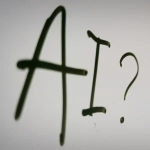 AI question mark concept written on white surface representing artificial intelligence topic